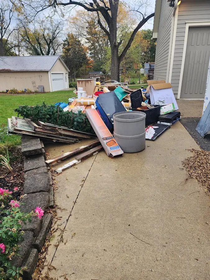 Dumpster being loaded with debris for Residential Dumpster Rental in Hudson